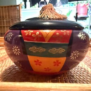 Vintage Japanese lacquerware trinket box with a lid and tassel.